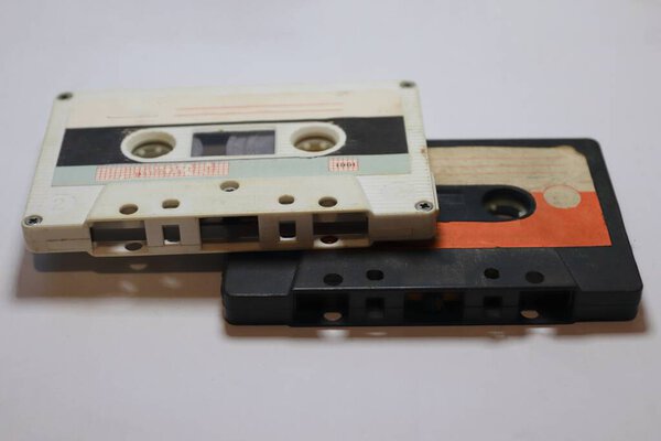 Two vintage audio cassettes on a light background  a symbol of the analog era, musical nostalgia, and retro design for creative projects.