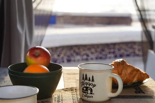 Stock image healthy breakfast from inside a caravan with sea view