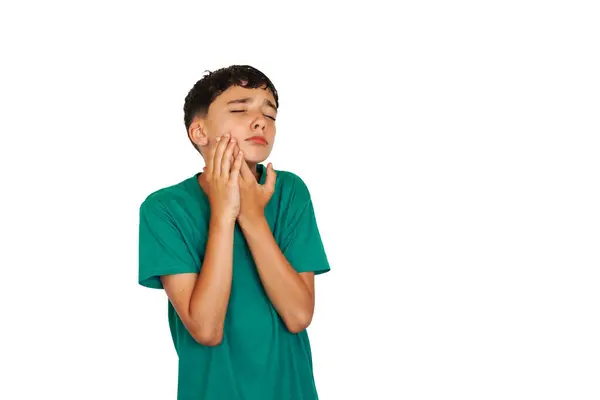 stock image preadolescent boy touching his jaw with intense odor gesture. toothache