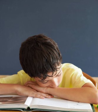 Çocuk, uyuyakalıyor, sıkılmış, kitap okuyor. okul konseptine geri dön