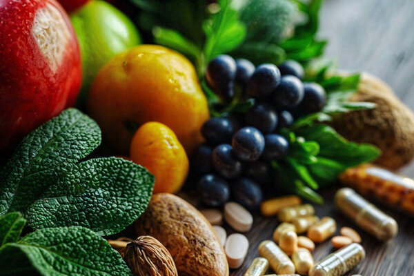 horizontal background of health food and food supplements on a rustic table. ai generated