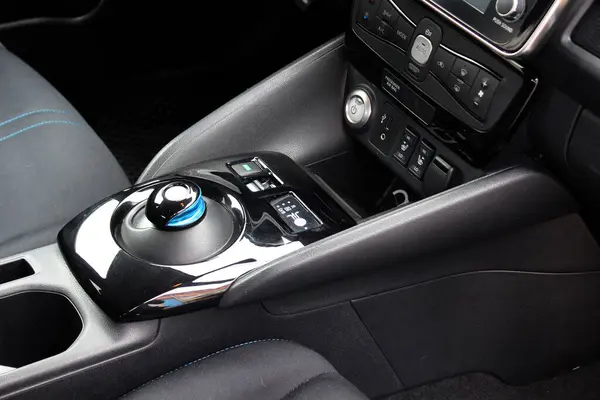 Automatic gear stick of a modern electric car. Modern car interior details. Car detailing. Automatic transmission lever shift.