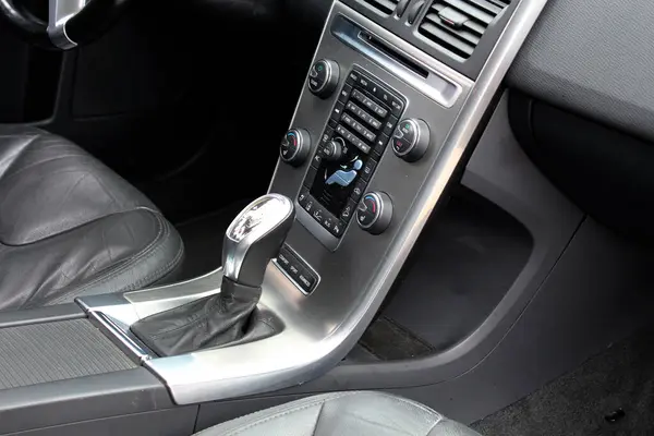 Automatic gear stick inside modern car. Automatic gearbox lever. Detail on a automatic gear shifter in a car. Leather interior modern SUV.