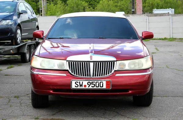 Stock image Vinnytsia, Ukraine; April 20, 2024. Red stretch limousine Lincoln Town Car the city street. Classic American car Lincoln Town Car at the parking. Front  view.