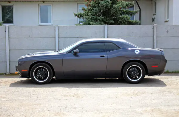 Vinnytsia, Ukrayna; 13 Nisan 2024. Gri Dodge Challenger şehir caddesinde. Amerikan süper şarjlı spor arabası Dodge Challenger park yerinde. Sol taraf görünümü.