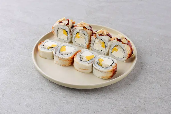 stock image Sushi delivery. Set of rolls in a disposable box on a black background