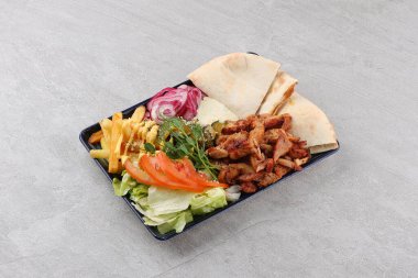 Gyros, chicken, with vegetables on plates, disassembled shawarma, fast food, appetizer, cooking