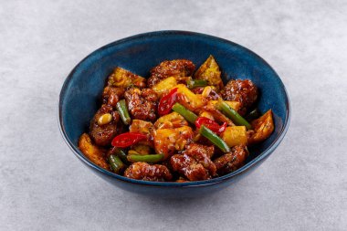 Ananaslı kızarmış teriyaki tavuğu, yeşil fasulye, fıstık, biber, tava, gri arka planda.