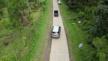 Lembang, Endonezya - 18 Mart 2024: Drone 's Eye View Car Traney along Scenic Forest Road