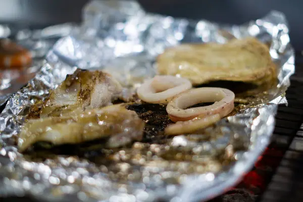Grilling Delights, Squid Seafood, Barbecue Sizzling on Aluminum Foil in Taiwan