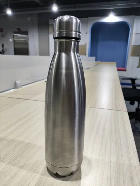 stock image Modern Stainless Steel Bottle in Contemporary Workspace