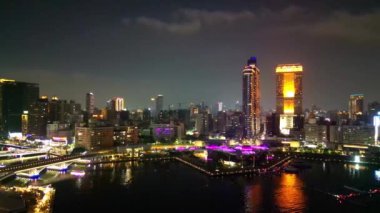Bu hava görüntüsü Kaohsiung 'un Aşk Nehri' ni gece çekerken, aydınlık Kaohsiung Müzik Merkezi ve yakındaki iskele de dahil olmak üzere canlı bir ufuk çizgisi ile kentin modern mimari güzelliğini nehrin yansımalarına karşı sergiliyor..