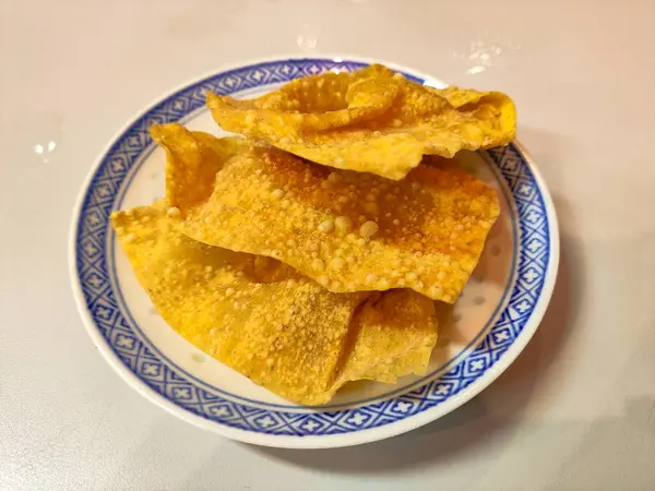 stock image Pangsit goreng is a crispy and delicious fried dumpling that is a popular Indonesian snack. Its golden crust and savory filling make it an irresistible treat for any time of day, perfect for a quick bite or appetizer.