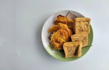 Kızarmış tofu ve kızarmış muz beyaz tabakta