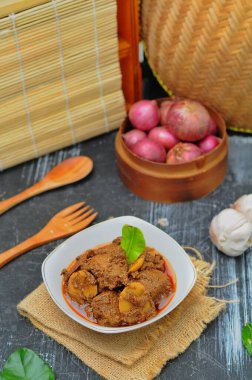 Rendang Jengkol, baharat ve hindistan cevizi sütüyle kaynatılmış köpek meyvesi. Geleneksel Endonezya yemekleri, baharatlı lezzet tadı tipik rendang ve yasal jengkol dokusu.