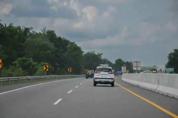 stock image Riau-Indonesia, May 3rd 2024 :cars traveling on the express way