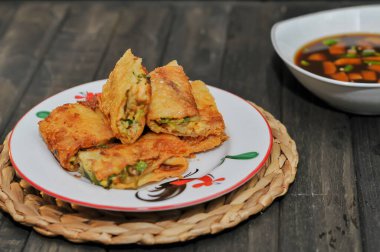 Martabak Mesir or Martabak Kubang is a snack made from flour dough containing eggs, seasoned meat, and leeks.perfect for recipe, article, catalogue, or any commercial usage, dark and moody clipart