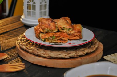 Martabak Mesir or Martabak Kubang is a snack made from flour dough containing eggs, seasoned meat, and leeks.perfect for recipe, article, catalogue, or any commercial usage, dark and moody clipart