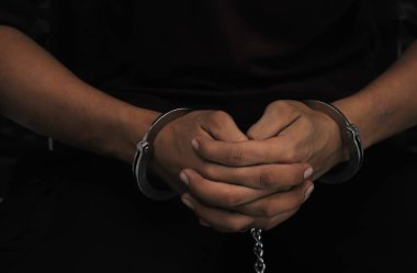 prisoner concept,Handcuffed hands of a prisoner in prison, Male prisoners were severely strained in the dark prison, violence,