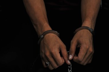 prisoner concept,Handcuffed hands of a prisoner in prison, Male prisoners were severely strained in the dark prison, violence,