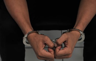 prisoner concept,Handcuffed hands of a prisoner in prison, Male prisoners were severely strained in the dark prison, violence,