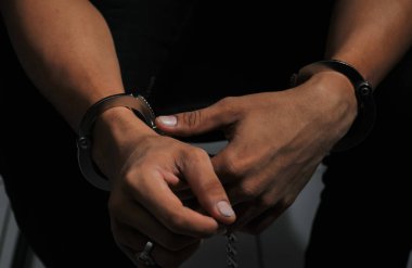 prisoner concept,Handcuffed hands of a prisoner in prison, Male prisoners were severely strained in the dark prison, violence,