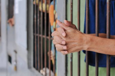 Siyah arka planda bir mahkumun elleri