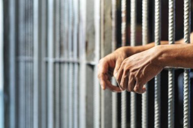 Siyah arka planda bir mahkumun elleri