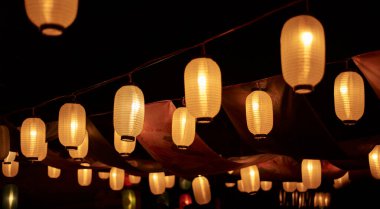 Colorful Chinese lanterns lit up at night clipart