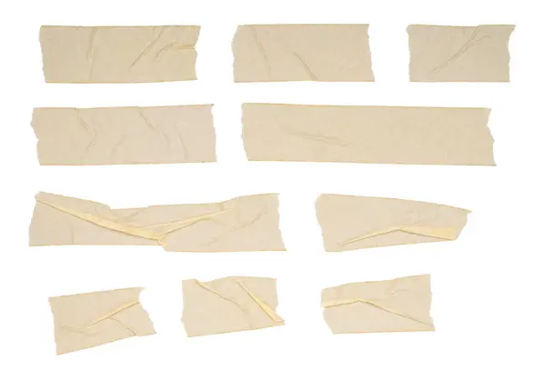 Bir çift buruşuk bej maskeleme bandı.