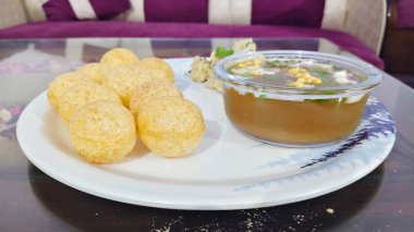 Panipuri or fuchka fhuchka or gupchup or golgappa or Pani ke Patake is a type of snack that originated in the Indian.  clipart