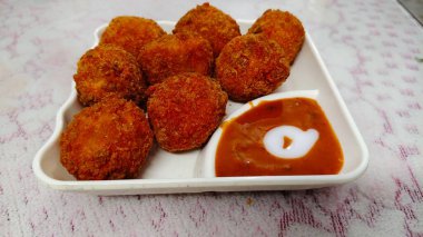 Veg Pakora in White Plate on Glass table top. Delicious crunchy veg kukure Momos. Kukure Momo to View. clipart