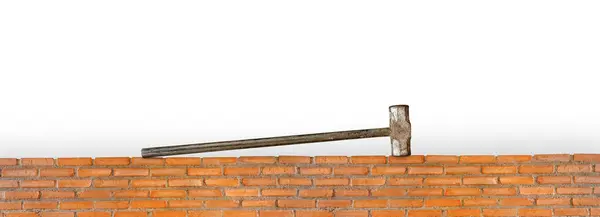 Pound hammer on red brick wall