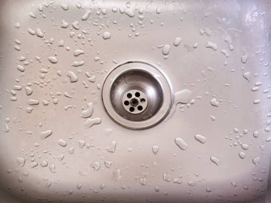 Drops of water after washing your hands in the sink. clipart