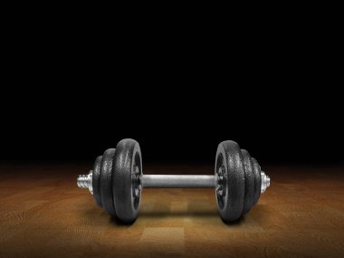 Kara demir halterler, ahşap bir zemine yerleştirilmiş, siyah arka plan..