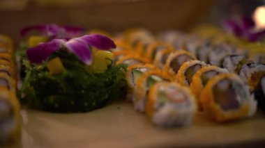 Bir restoranda suşi rulosu. Suşi rulosu. Somon, ton balığı ve avokado ile rulo