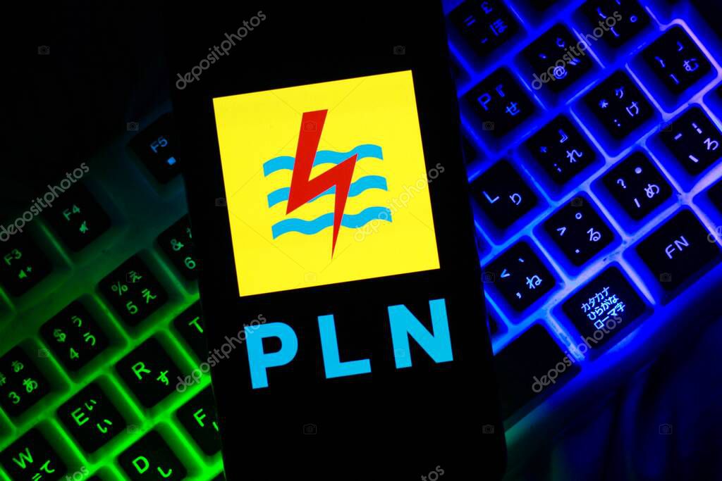 Indonesia - March,18th 2024: PLN logo is displayed on a smartphone screen against a dark background.