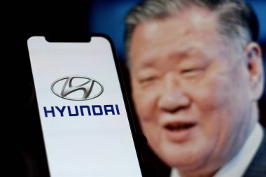 Indonesia - March 30th 2024: Hyundai logo is a multinational car company from South Korea with CEO Chung Mong Koo in background. clipart