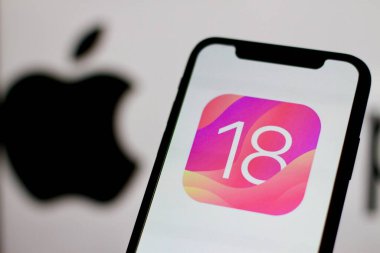 Indonesia - April 6th 2024: Display of the iOS 18 logo is displayed on the Apple smartphone screen clipart