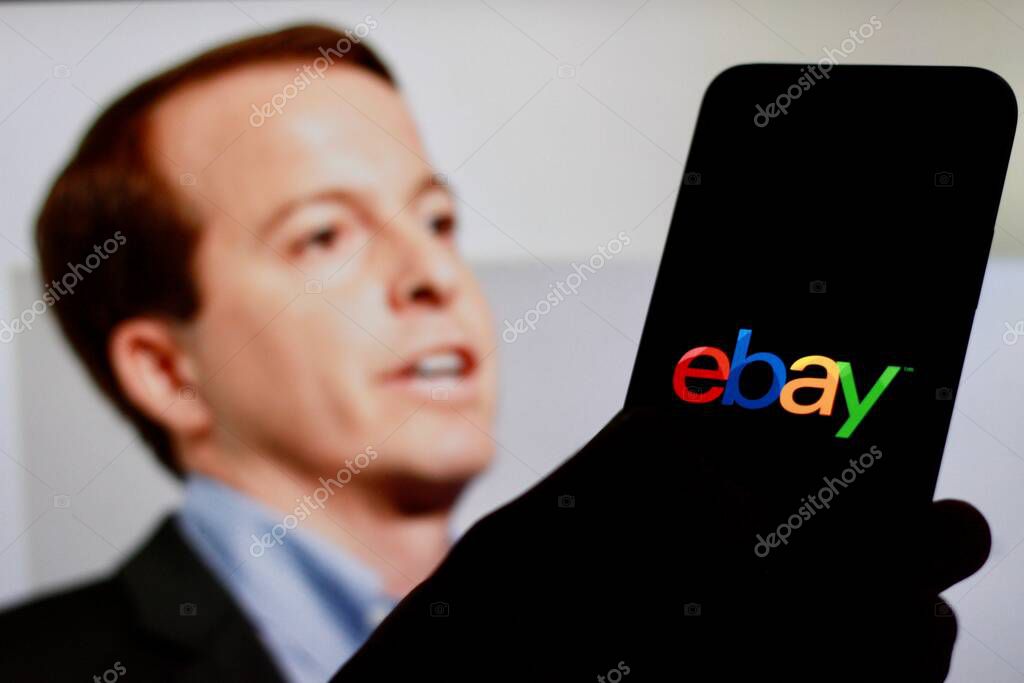 Indonesia - April 16th 2024: Logo of Ebay is displayed on a smartphone screen with CEO Jamie Iannone in the background