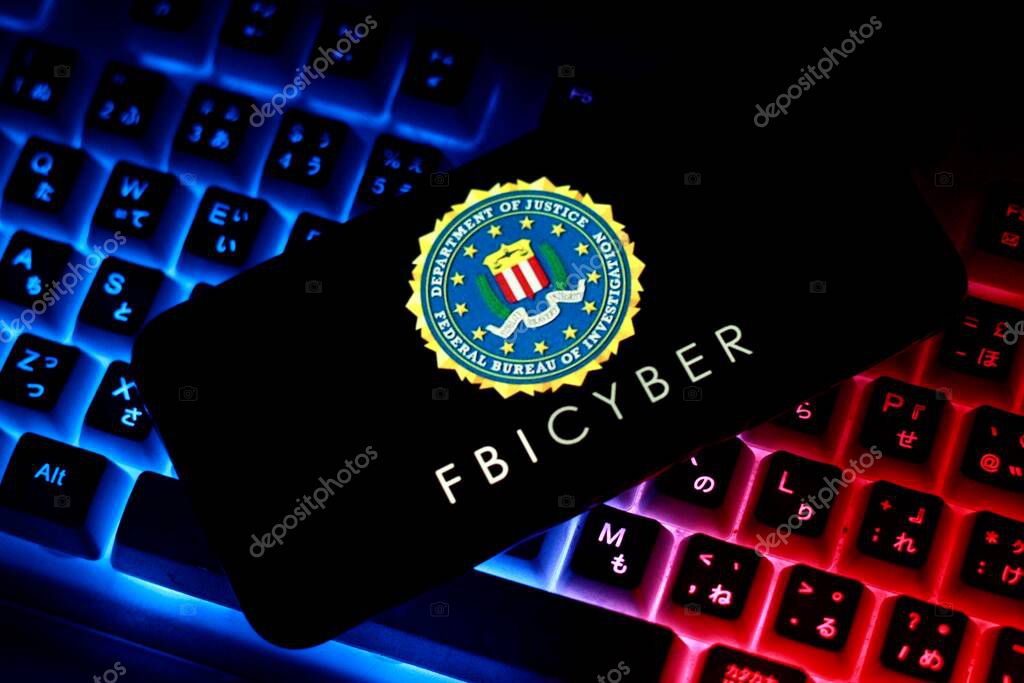 The logo of Federal Bureau of Investigation,FBI Cyber, With america flag in ghe background.Indonesia - April 29th 2024. Computer keyboard background