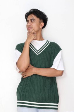 Beyaz arka planda düşünen Asyalı genç bir adamın portresi 