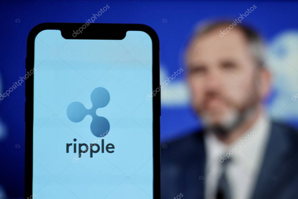 In this Photo xrp ripple Cryptocurrency logo is displayed on a smartphone screen With CEO Brad Garlinghouse in the background.indonesia-may 17th 2024.