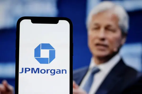 stock image JPMorgan Chase logo displayed on smartphone, American banking company, with Jamie Dimon in the background.Indonesia-April 3,2024.