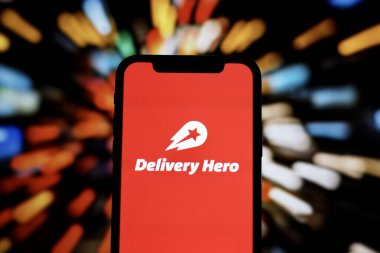 INDONESIA - JUNE 1ST, 2024: In this photo illustration, the logo of Delivery Hero, a online food delivery company, is displayed on a smartphone screen clipart
