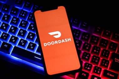 INDONEZYA - 1 Haziran 2024: Bu resimde, çevrimiçi bir gıda dağıtım şirketi olan Doordash 'ın logosuna sahip bir kişi akıllı telefon ekranında sergileniyor.