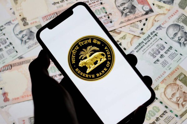 logo of Reserve Bank of India,TheRBI, is displayed on asmartphone screen with indian money in the background.indonesia - June 10th 2024.