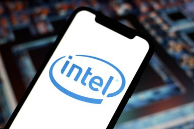 In this photo illustration,the logo of Intel,is displayed on a smartphone withstock market declines in the background.indonesia - June 23th 2024. clipart