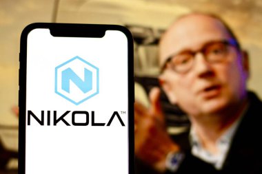 In this photo illustration,the logo of Nikola,with CEO Stephen Girsky in the background.indonesia - June 23th 2024. clipart