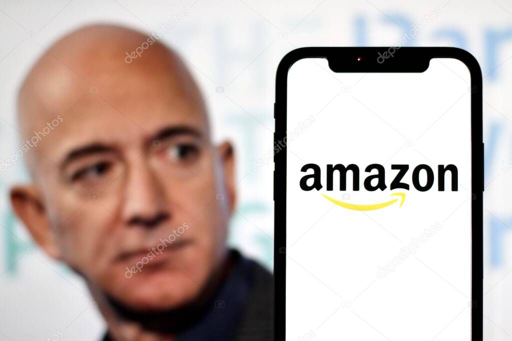 In this photo illustration,the logo of Amazon,is displayed on a smartphone with founder Jeff Bezos in the background.indonesia - June 23th 2024.